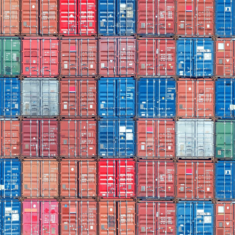 Stacked shipping containers filling the image from edge to edge.