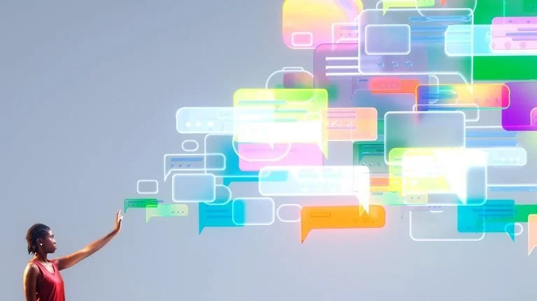 A person reaches into a cascade of colorful message bubbles, symbolizing agentic AI orchestrating empathetic, human-centered customer conversations at scale.